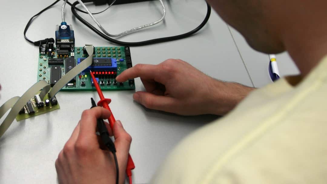 working on an electronics circuit board
