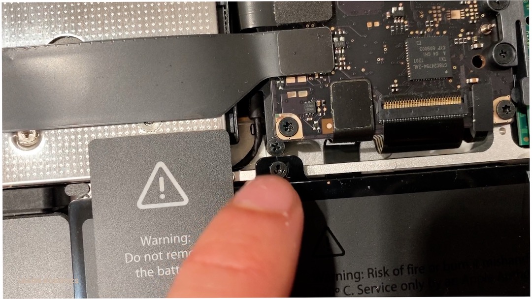 remove an Apple Mac battery using a three-prong screwdriver