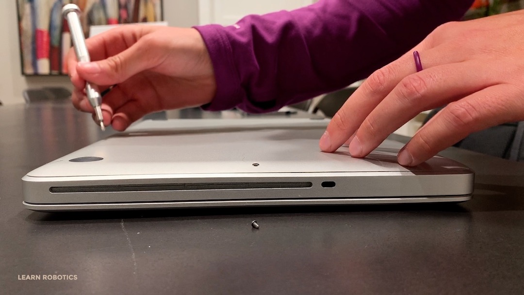 remove the back cover of a macbook pro using a Torx screwdriver
